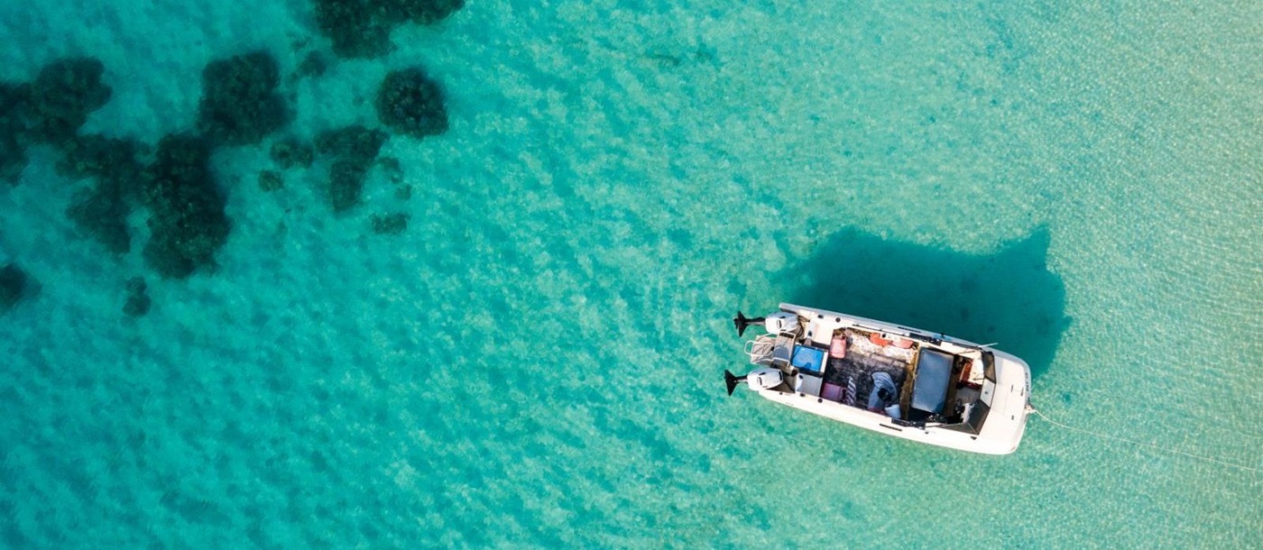 Aerial view of boat in crystal clear waters at Lizard Island, Australia 