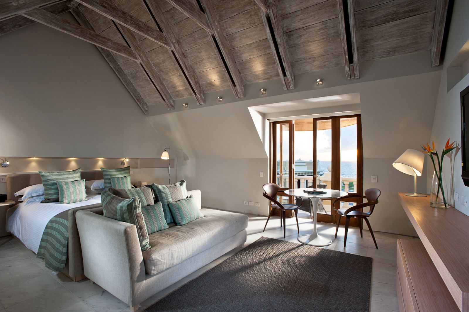 Grey guest suite bedroom and living area at Sofitel Legend Santa Clara in Cartagena, Colombia