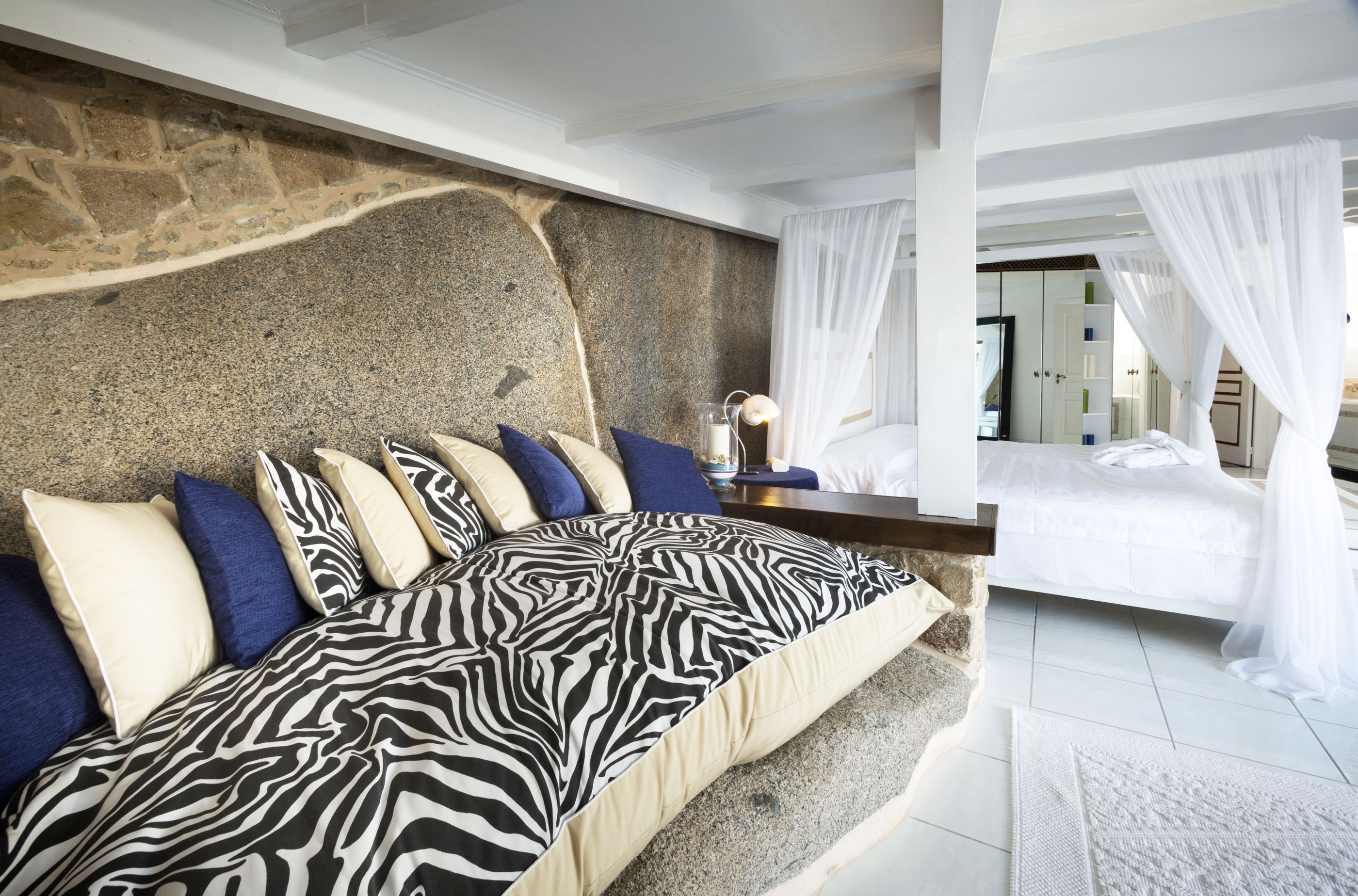 striped furnishings in a bedroom at Hotel  & Spa des Pecheurs, Corsica, France