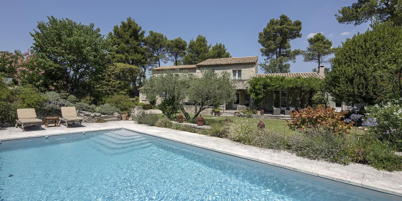 Pool, sun loungers, and beautiful gardens at Mas Cecile, luxury villa in Provence, France