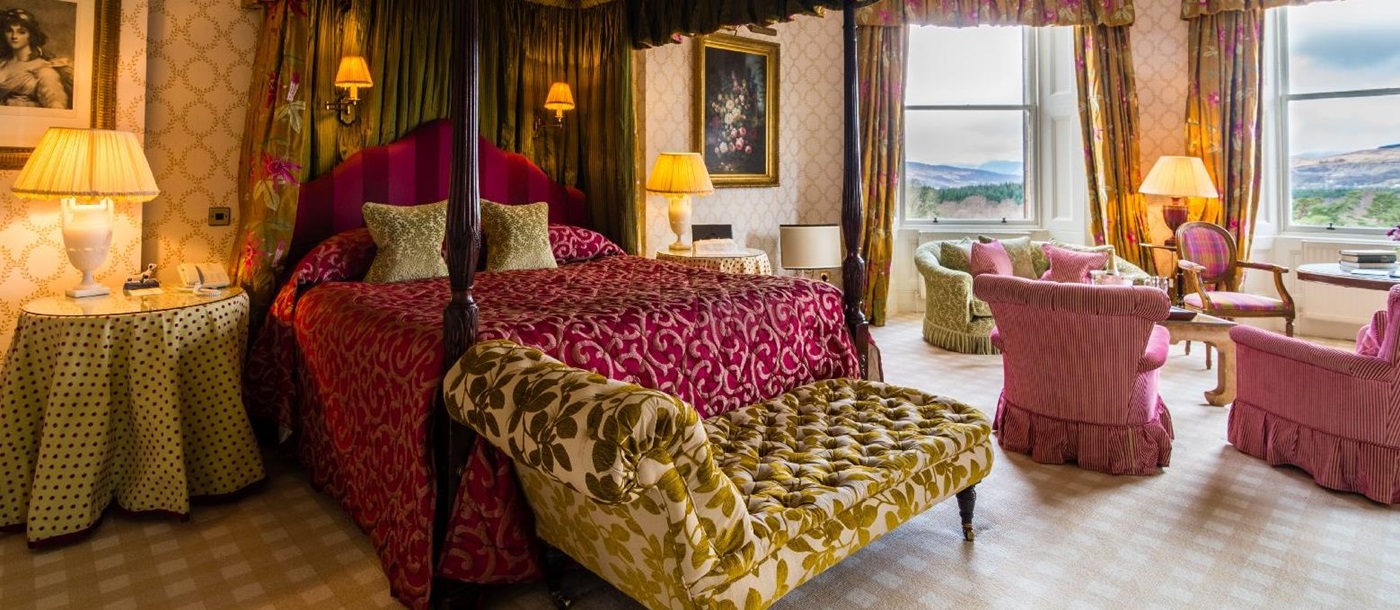 Spacious room with four poster bed at the Inverlochy Castle Hotel in Scotland