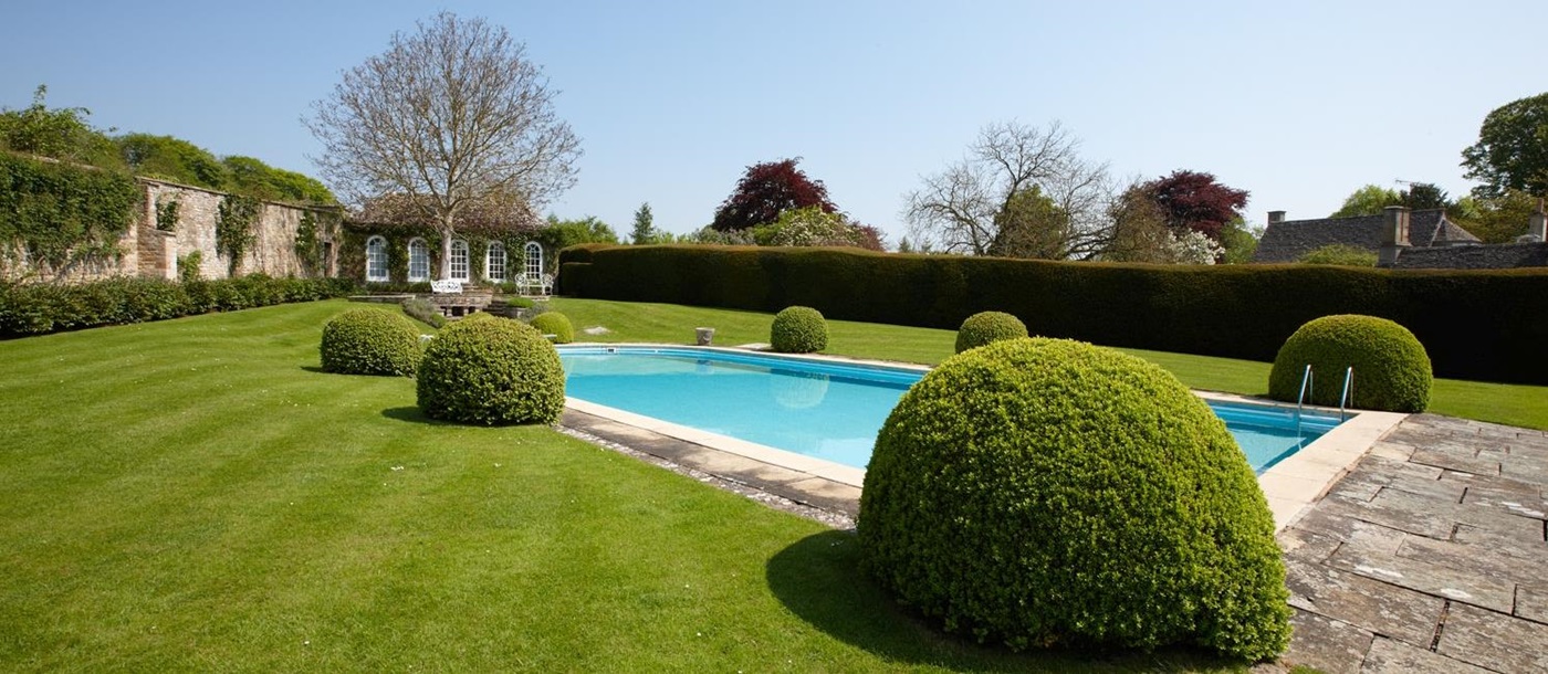 Swimming pool at Living room with fireplace in Cornwell Manor, Cotswolds