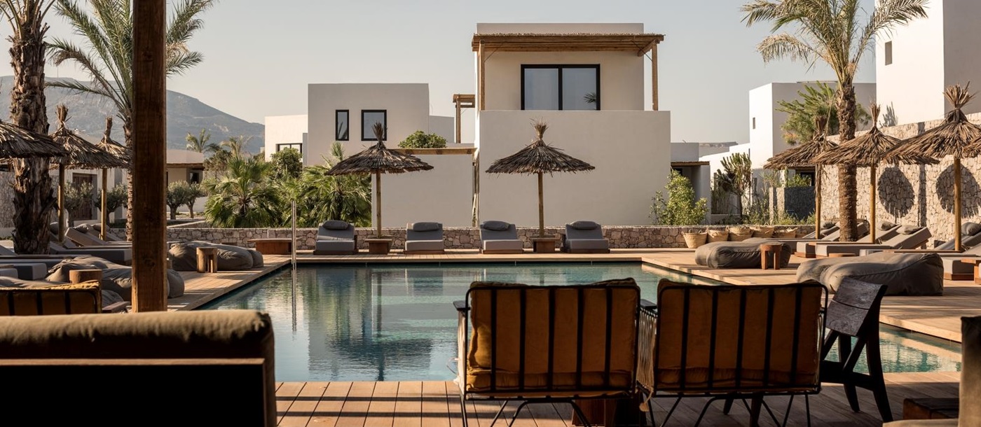 Pool with plenty of seating, loungers and parasols at luxury hotel OKU Kos in Greece