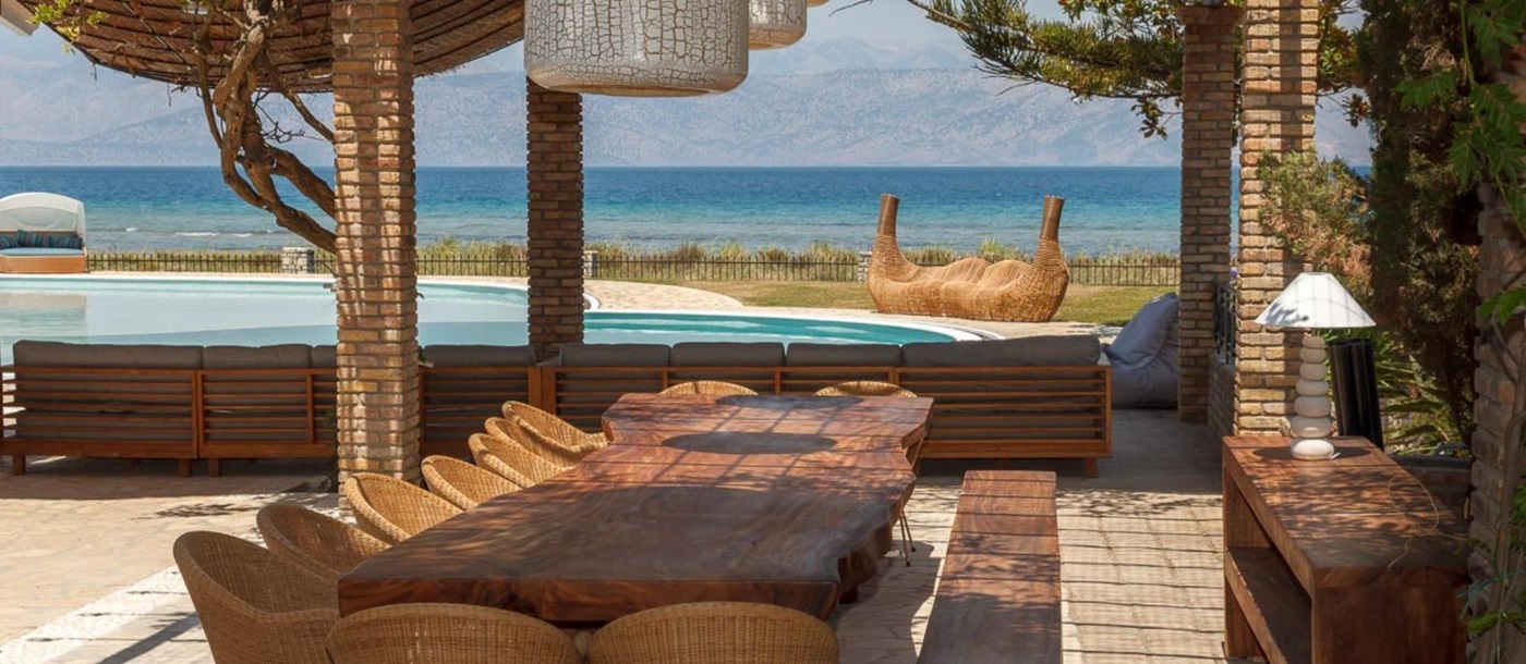 Outdoor dining area with sea view at Villa Paralia