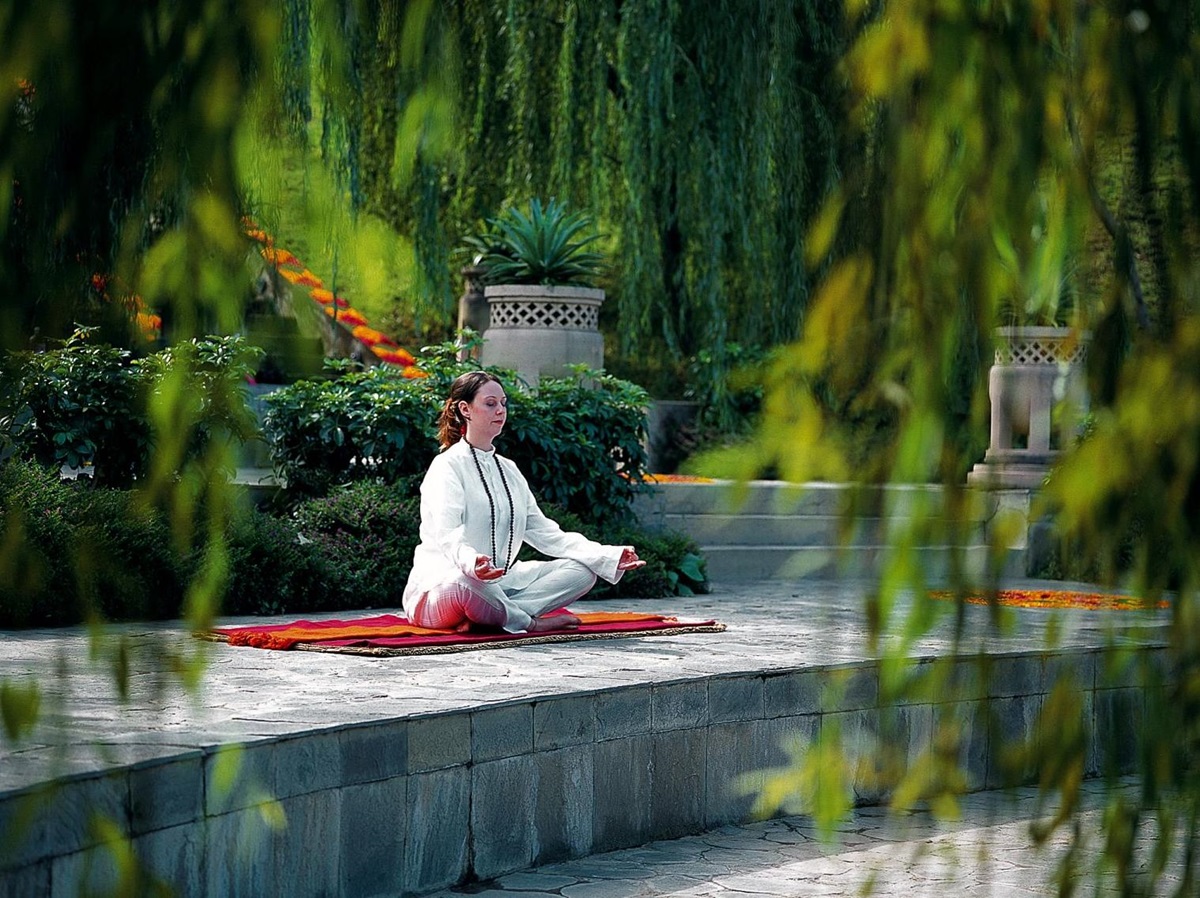 Guest meditating in the grounds of Ananda in the Himalayas India