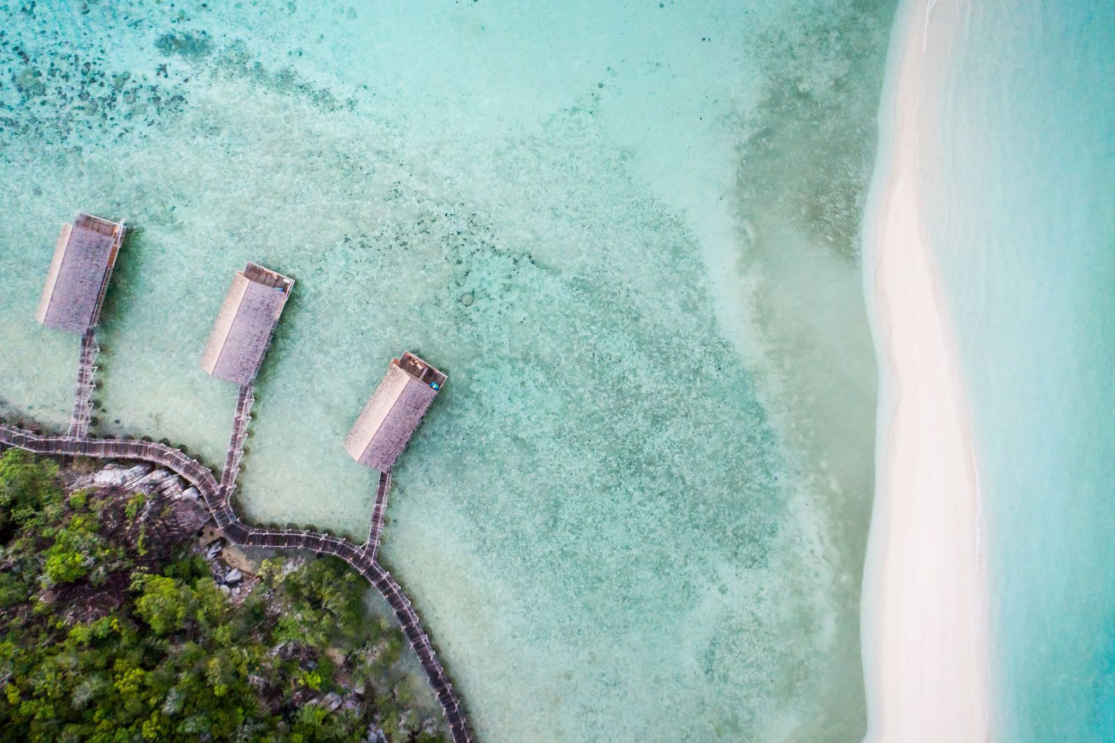 Aerial view of the overwater bungalows at Bawah Private Reserve Indonesia