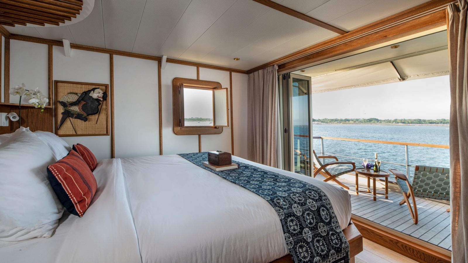 Double cabin and balcony view onboard the Kudanil Explorer phinisi in Indonesia