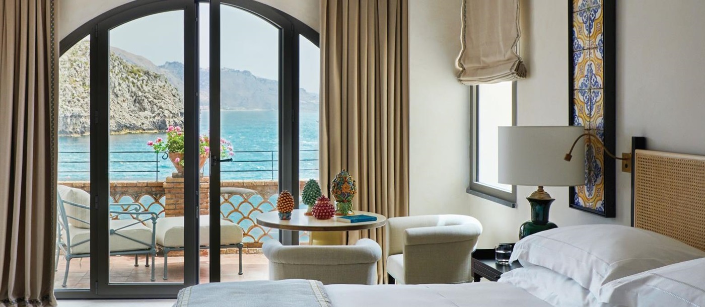Guest room with balcony at Belmond Villa Sant'Andrea in Sicily