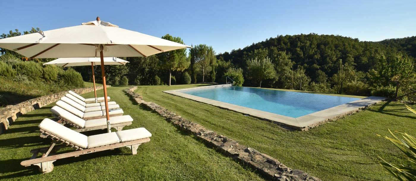 The pool and loungers at Villa il Falco.