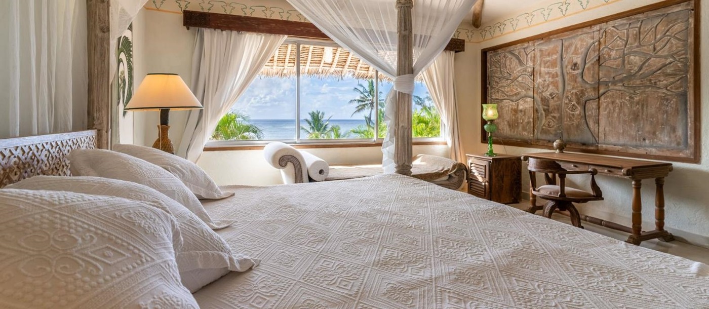 Guest bed with ocean views at Alfajiri Garden Villa on Diani Beach in Kenya