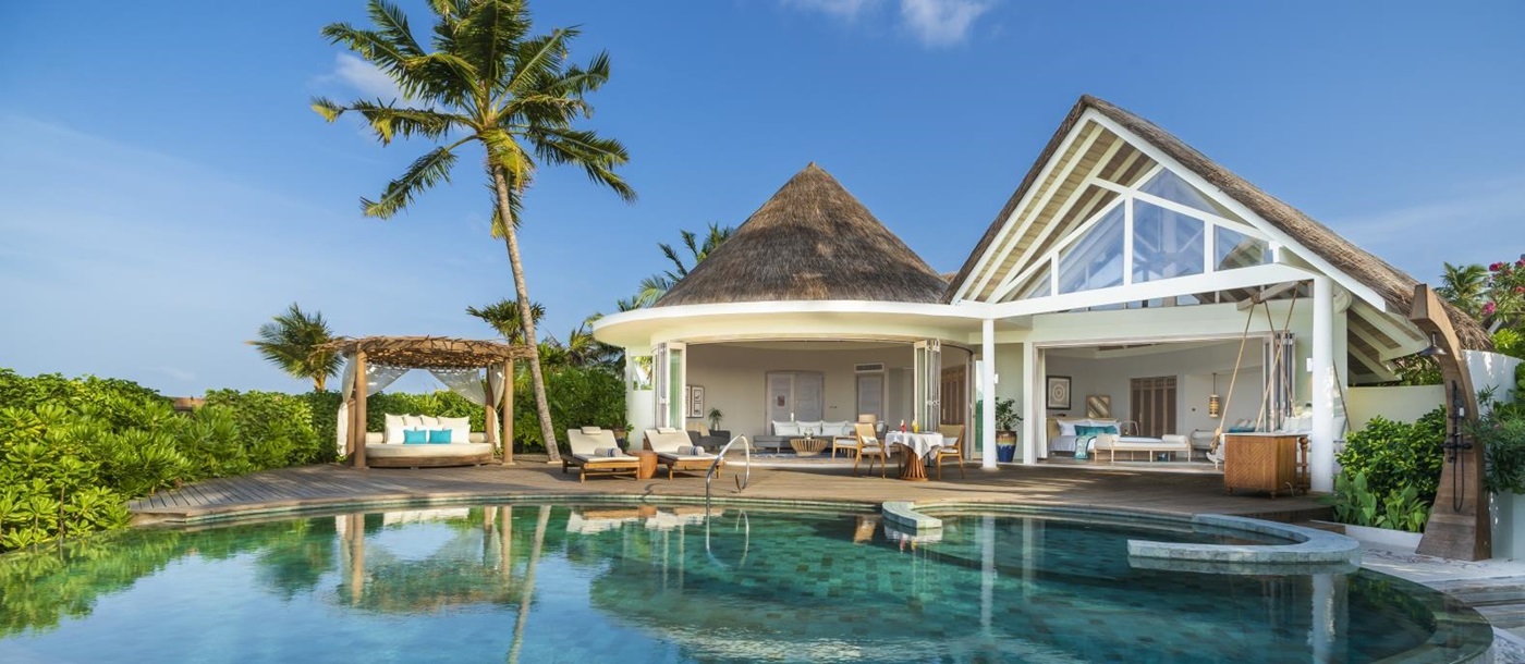 Exterior view of a Beach REsidence with private pool, pool cabana, loungers, open bedroom and living area at luxury resort Milaidhoo in the Maldives