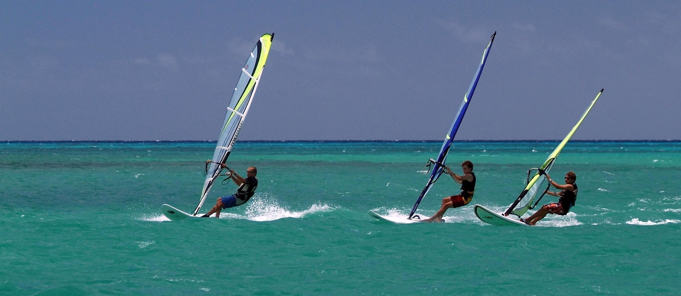 Three windsurfers near 20 Degrees South, Mauritius