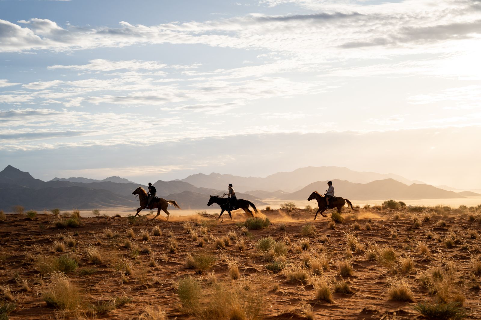 Guests riding through the Namib Rand Nature Reserve during a stay at one of the luxury lodges of Wolwedans in Namibia