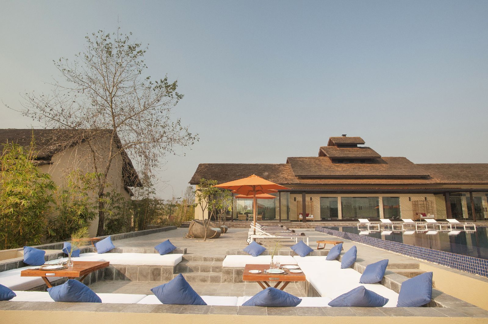 Pool and sun terrace at Meghauli Serai luxury safari camp Nepal
