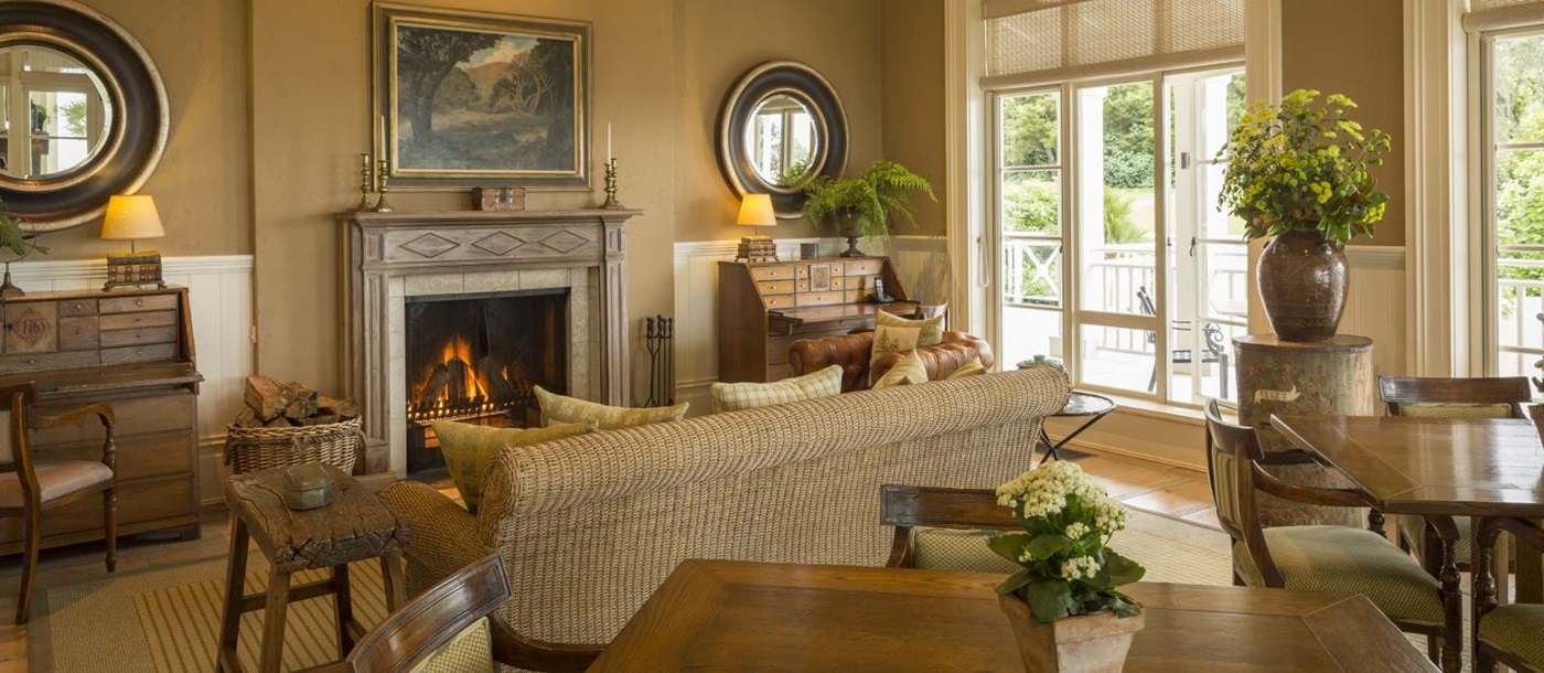 Cosy lounge at Kauri Cliffs with a fireplace