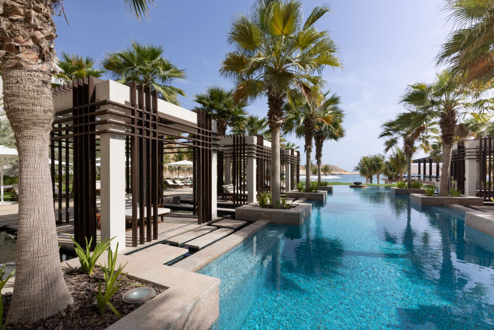 Huts by the poolside at Jumeirah Muscat Bay in Oman