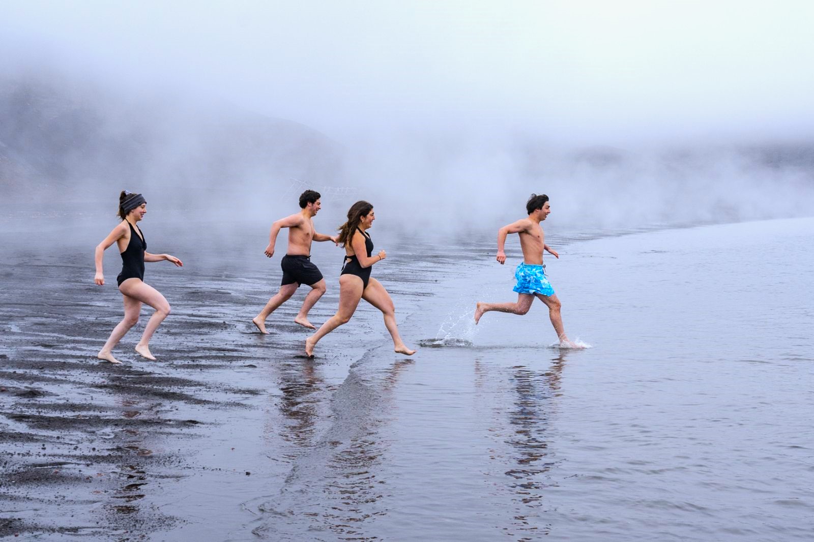 Guests running into the Antarctic for a polar plunge