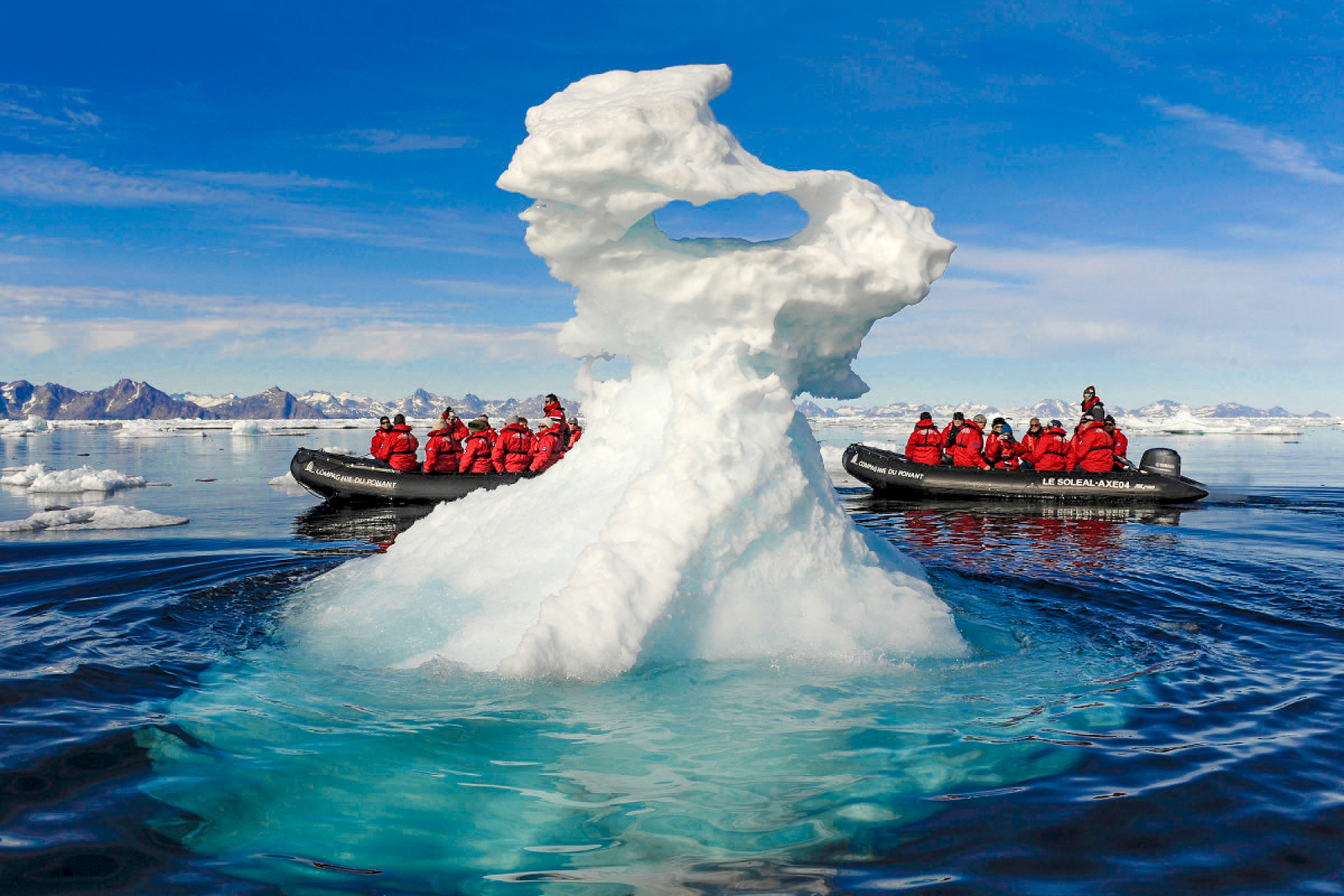 Ponant Arctic cruise guests on zodiac safari viewing iceberg formations 