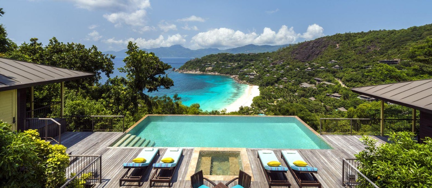 A swimming pool overlooking the ocean at Four Seasons Seychelles