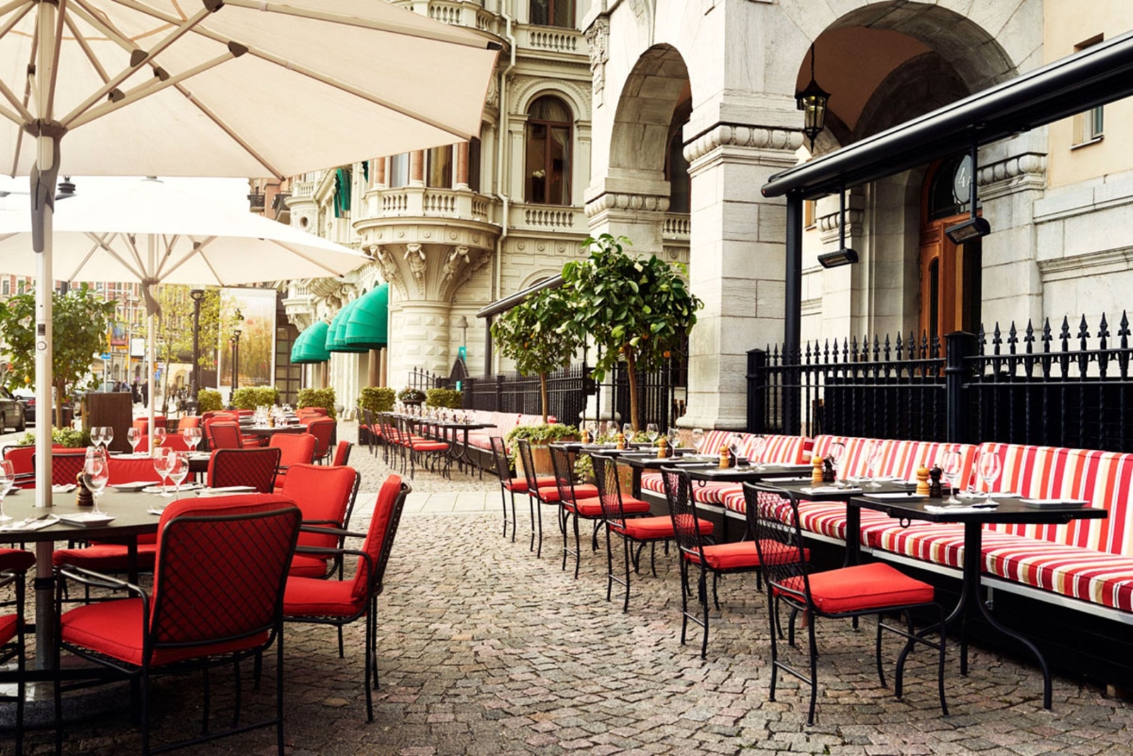 Outdoor seating on a cobbled square with parasols
