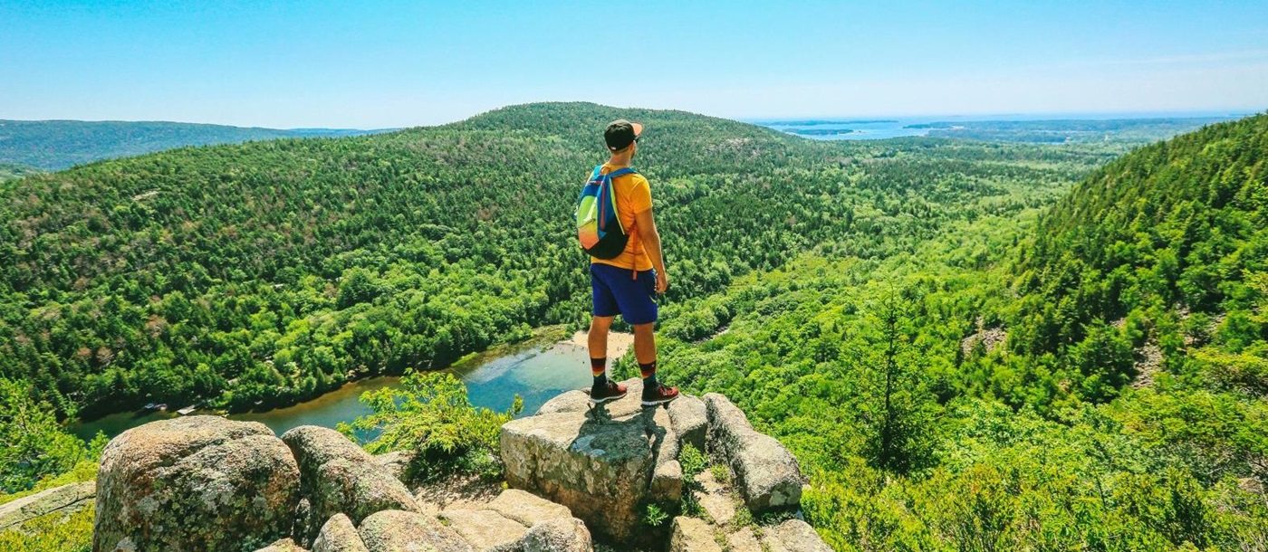 Hiker admiring views in Acadia National Park Maine USA