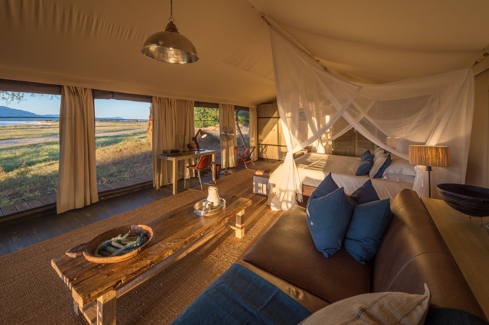 Interior of tented room with view at luxury camp Ruckomechi