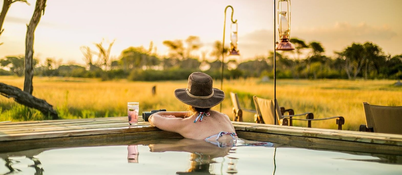 Guest enjoying the swimming pool at The Hide safari lodge Zimbabwe