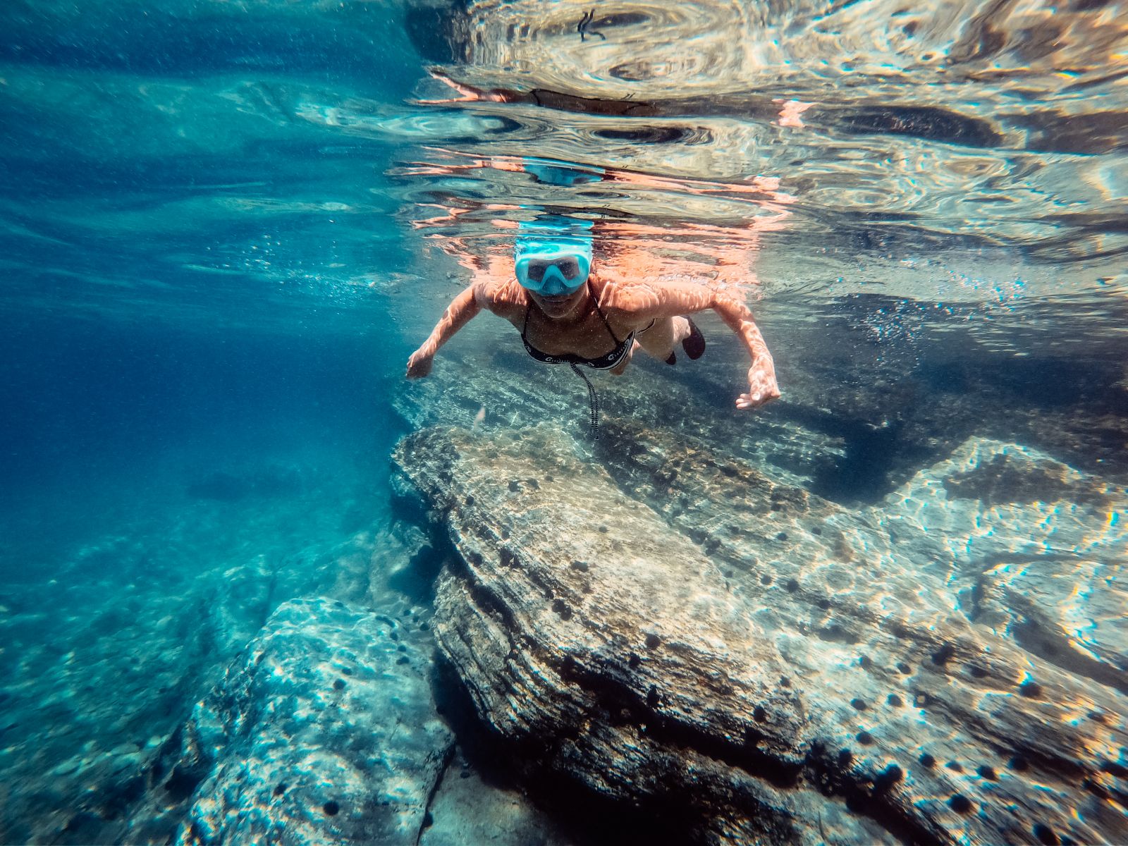 Young woman snorkelling in turquoise blue waters
