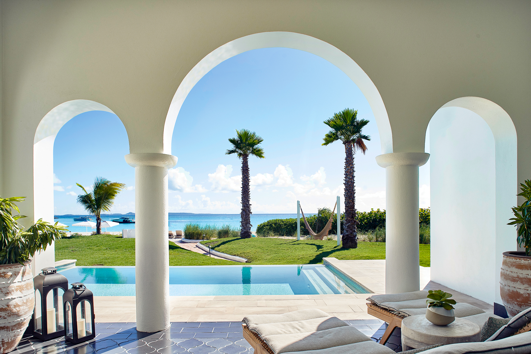 Arches with a view of the swimming pool and ocean at Belmond's Cap Juluca resort in Anguilla