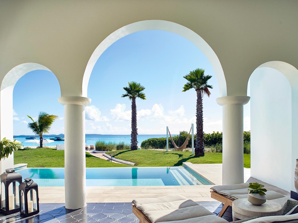 Arches with a view of the swimming pool and ocean at Belmond's Cap Juluca resort in Anguilla