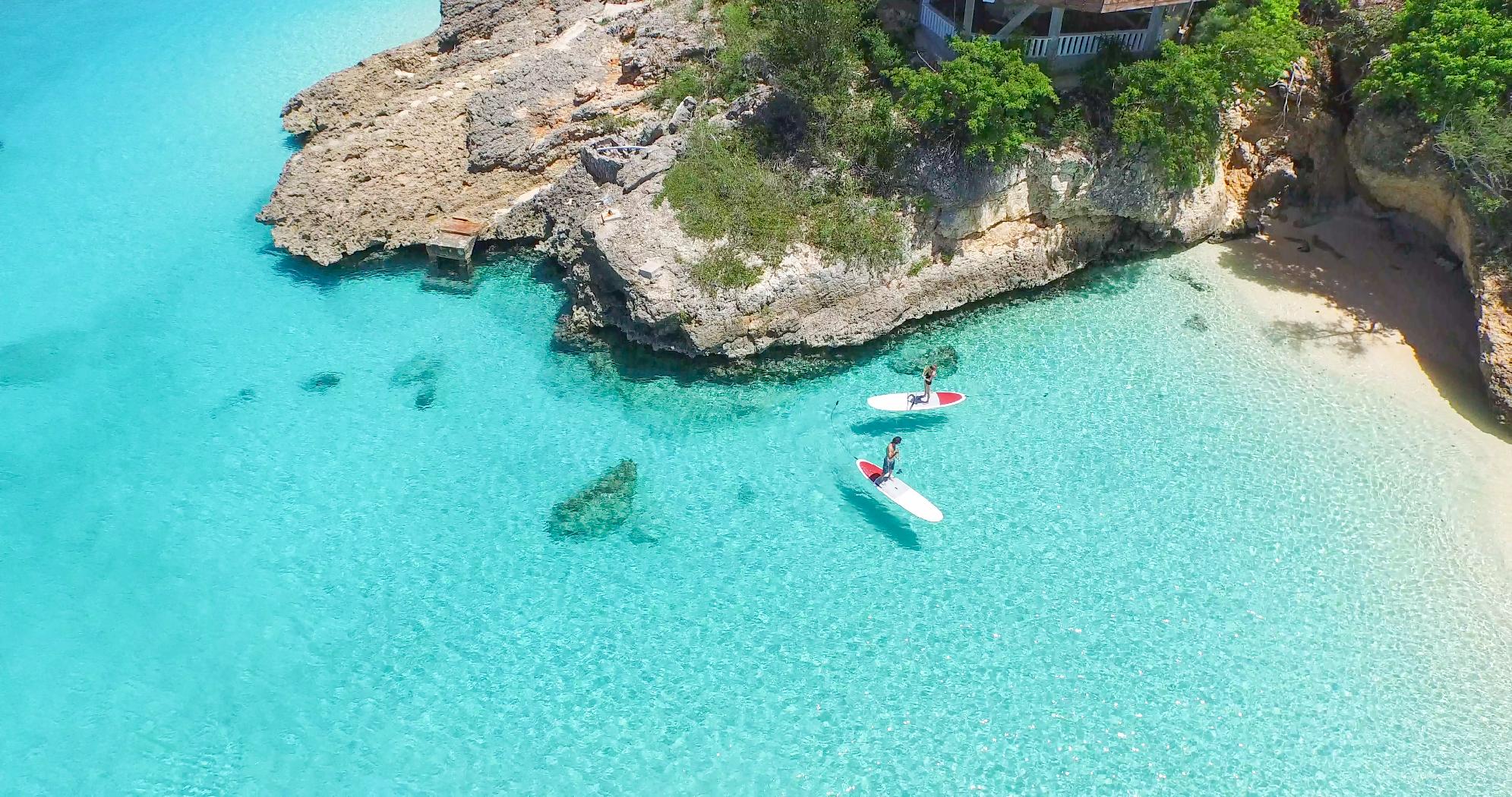 aerial shot of a couple paddle boarding near Malliouhana, Anguilla