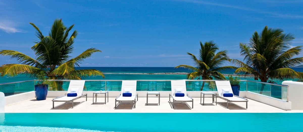 swimming pool and sun loungers of le bleu, luxury villa in anguilla