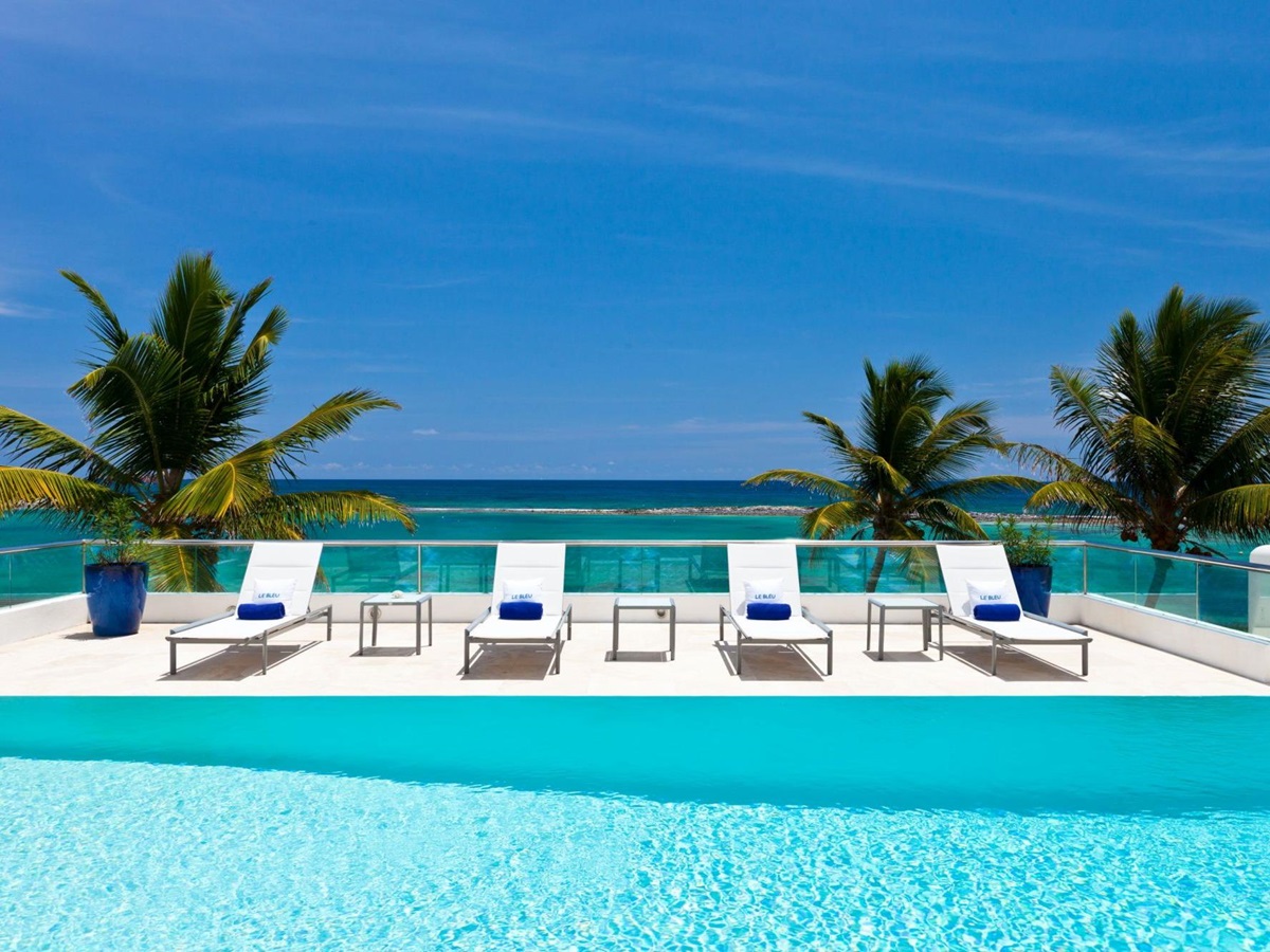 swimming pool and sun loungers of le bleu, luxury villa in anguilla