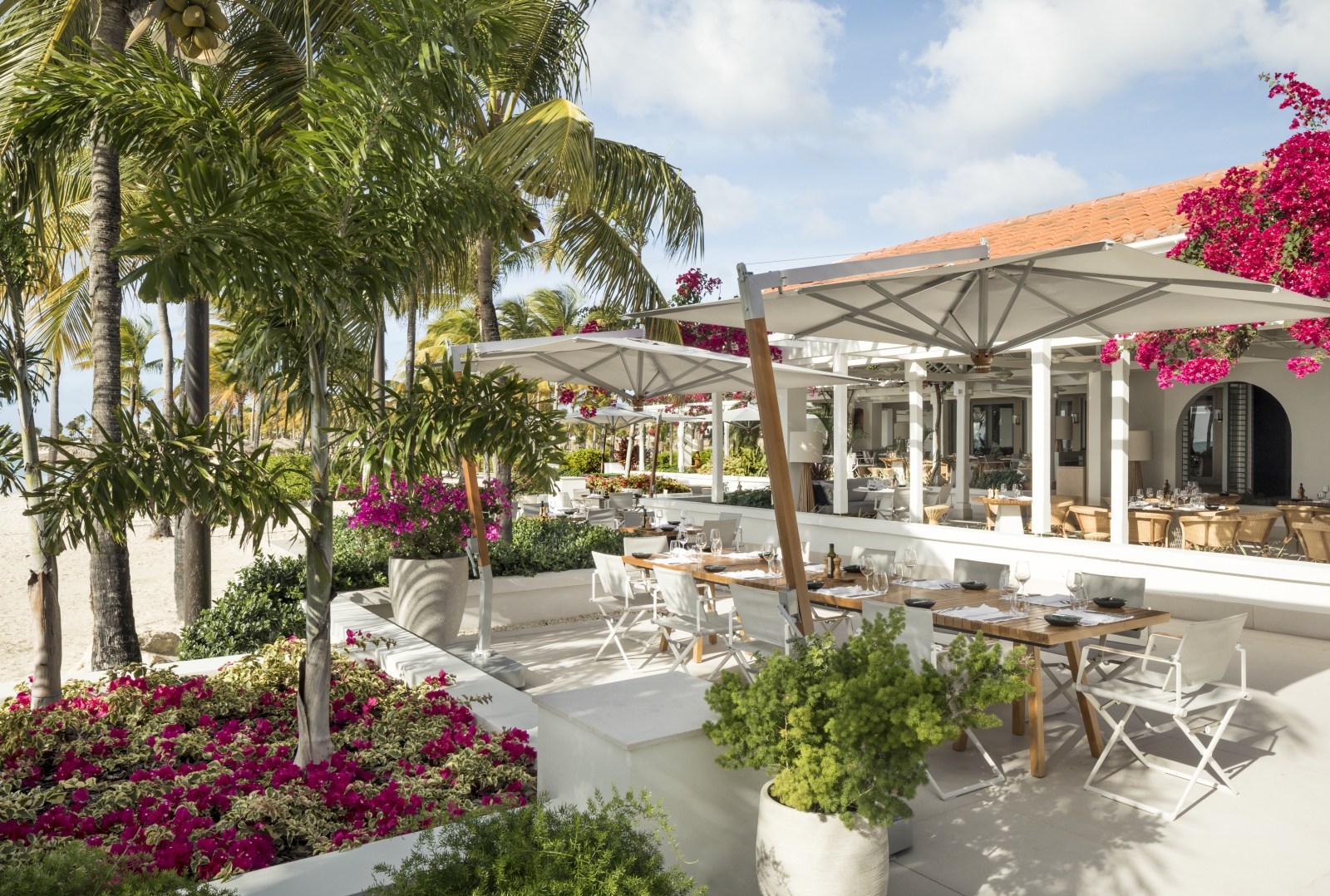 Outdoor dining by the beach at Jumby Bay