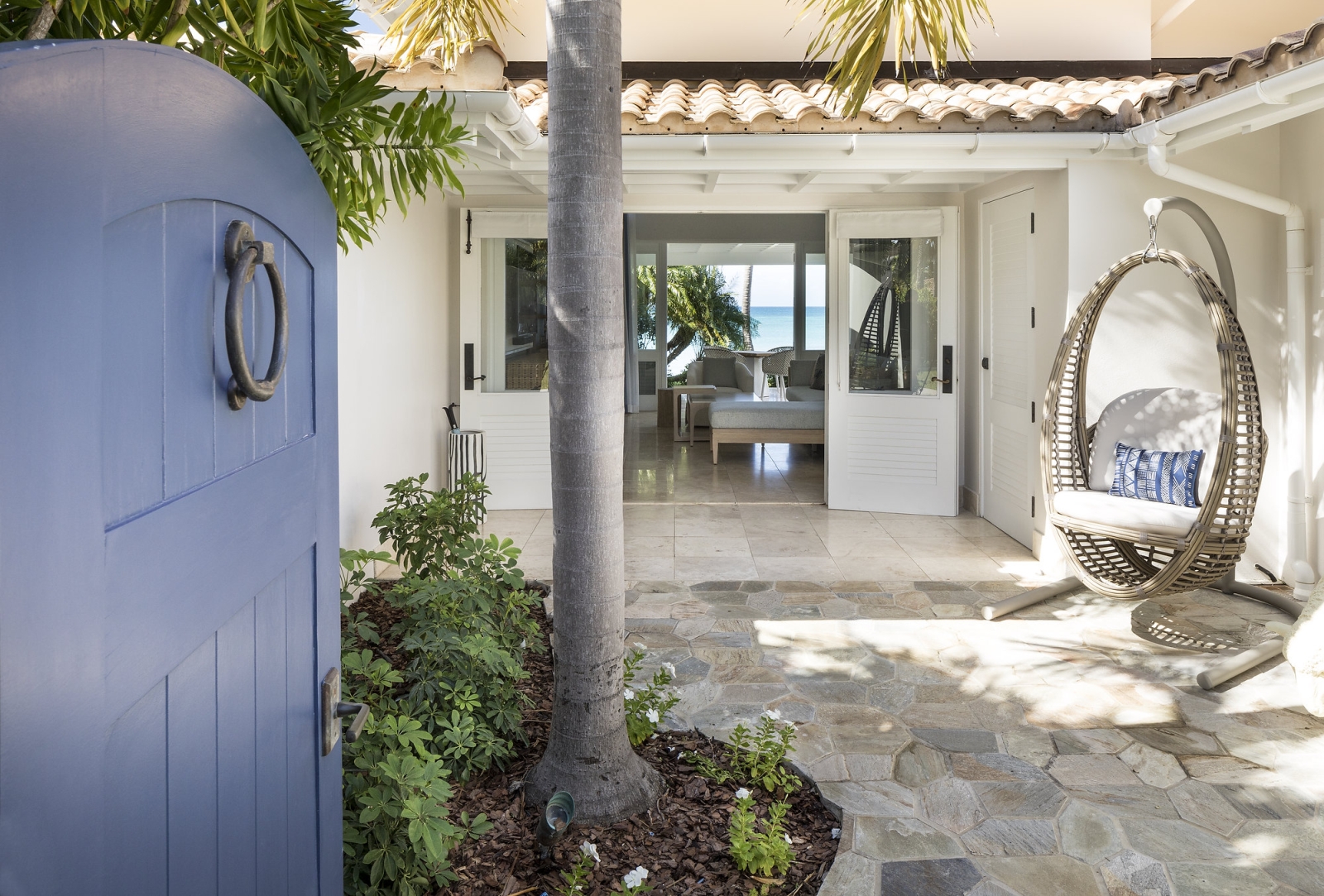 Entrance to a room with gate and hanging egg chair