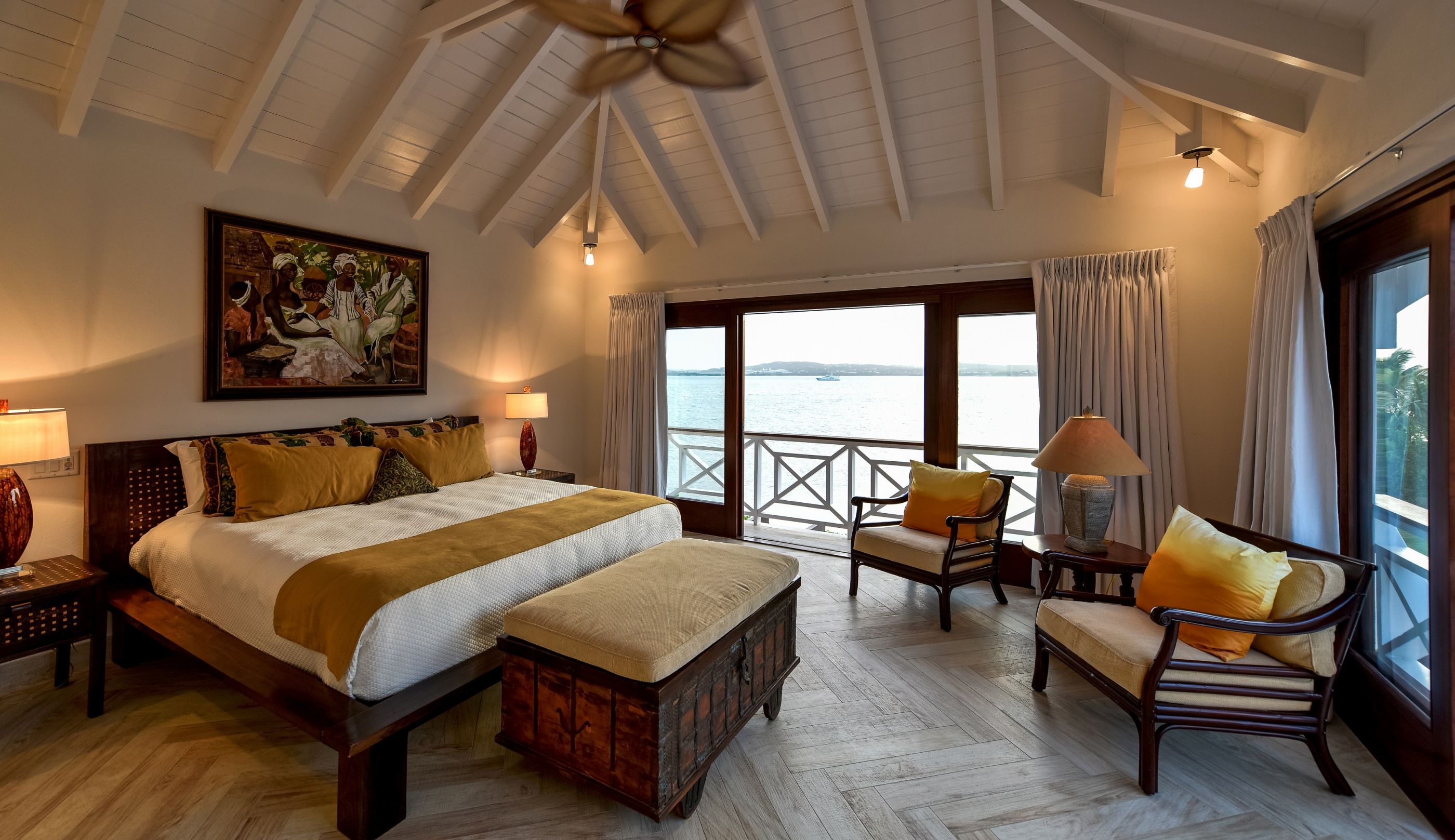 yellow double bedroom with terrace access at Blue Pelican, Antigua