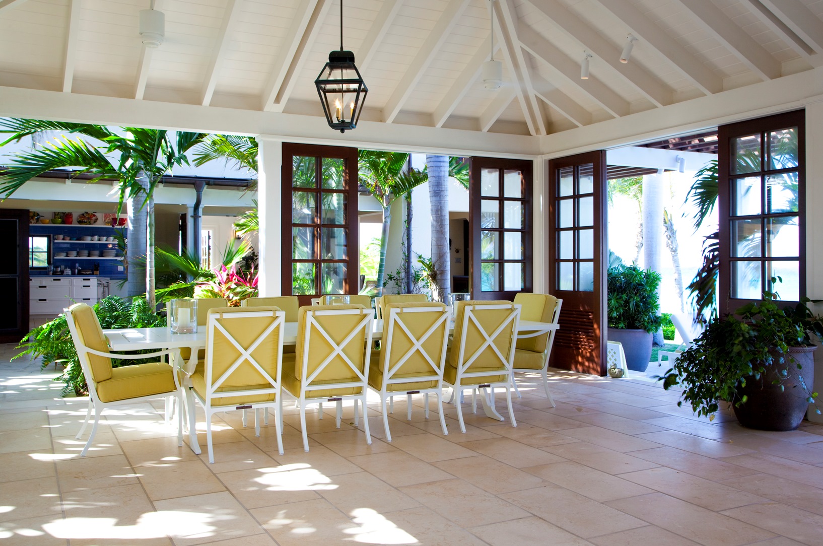 A dining table with terrace access at Frangipani, Antigua
