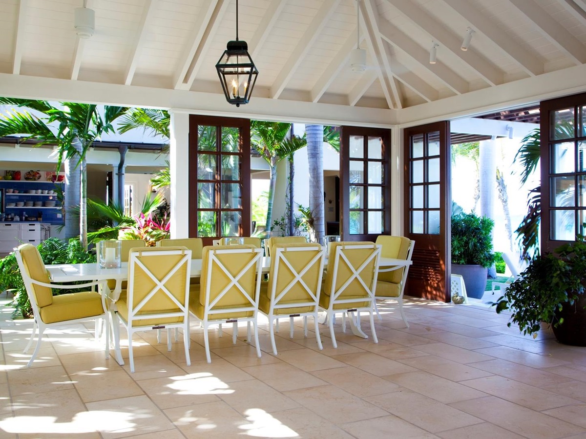 A dining table with terrace access at Frangipani, Antigua