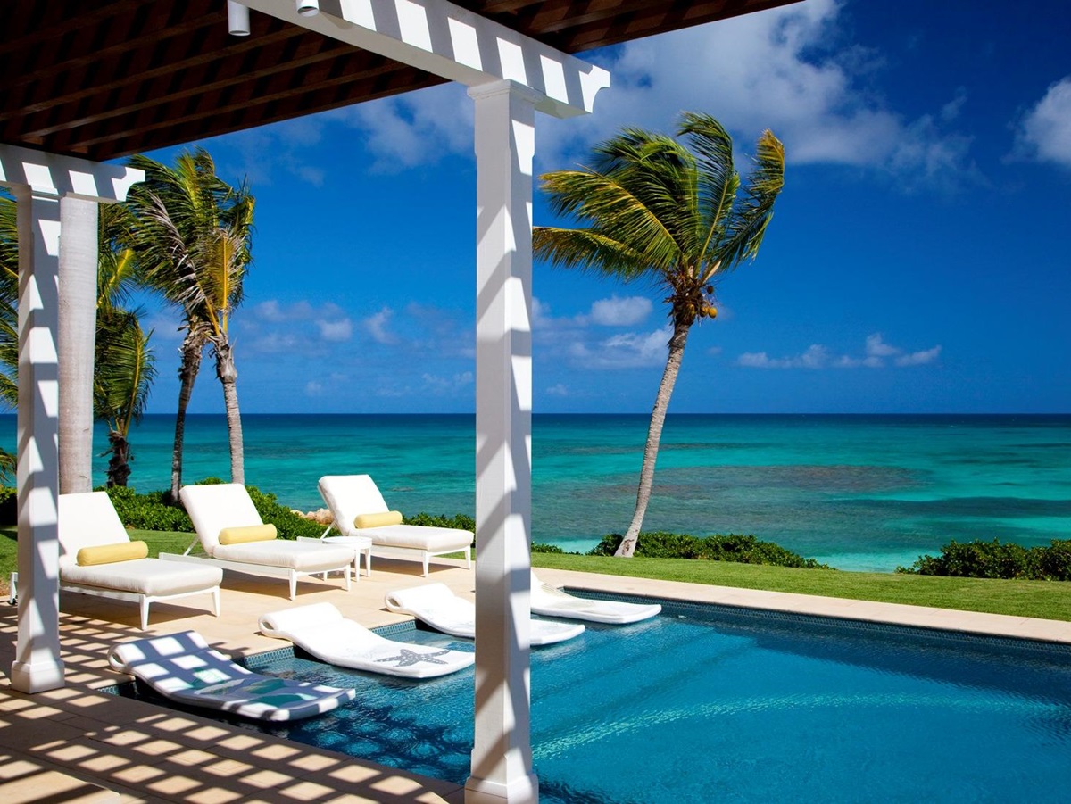 The swimming pool with ocean view at Frangipani, Antigua