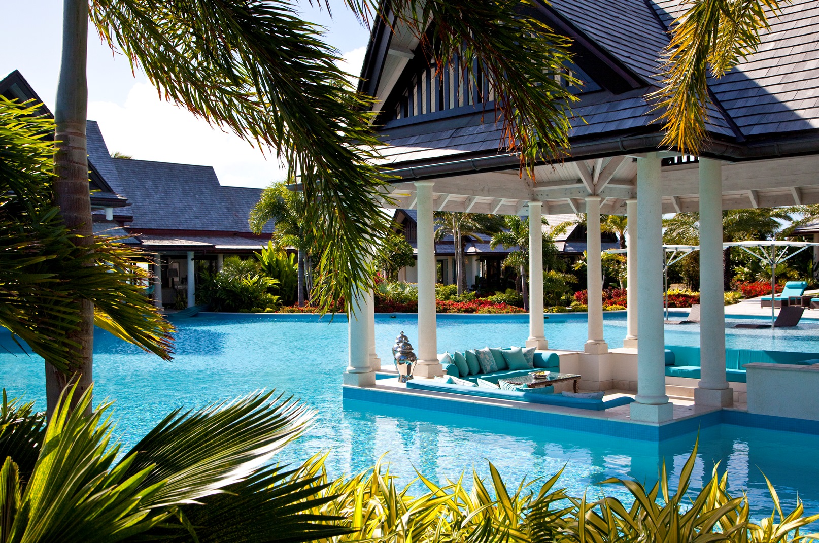 the dining area at the swimming pool at lazy lizard, antigua
