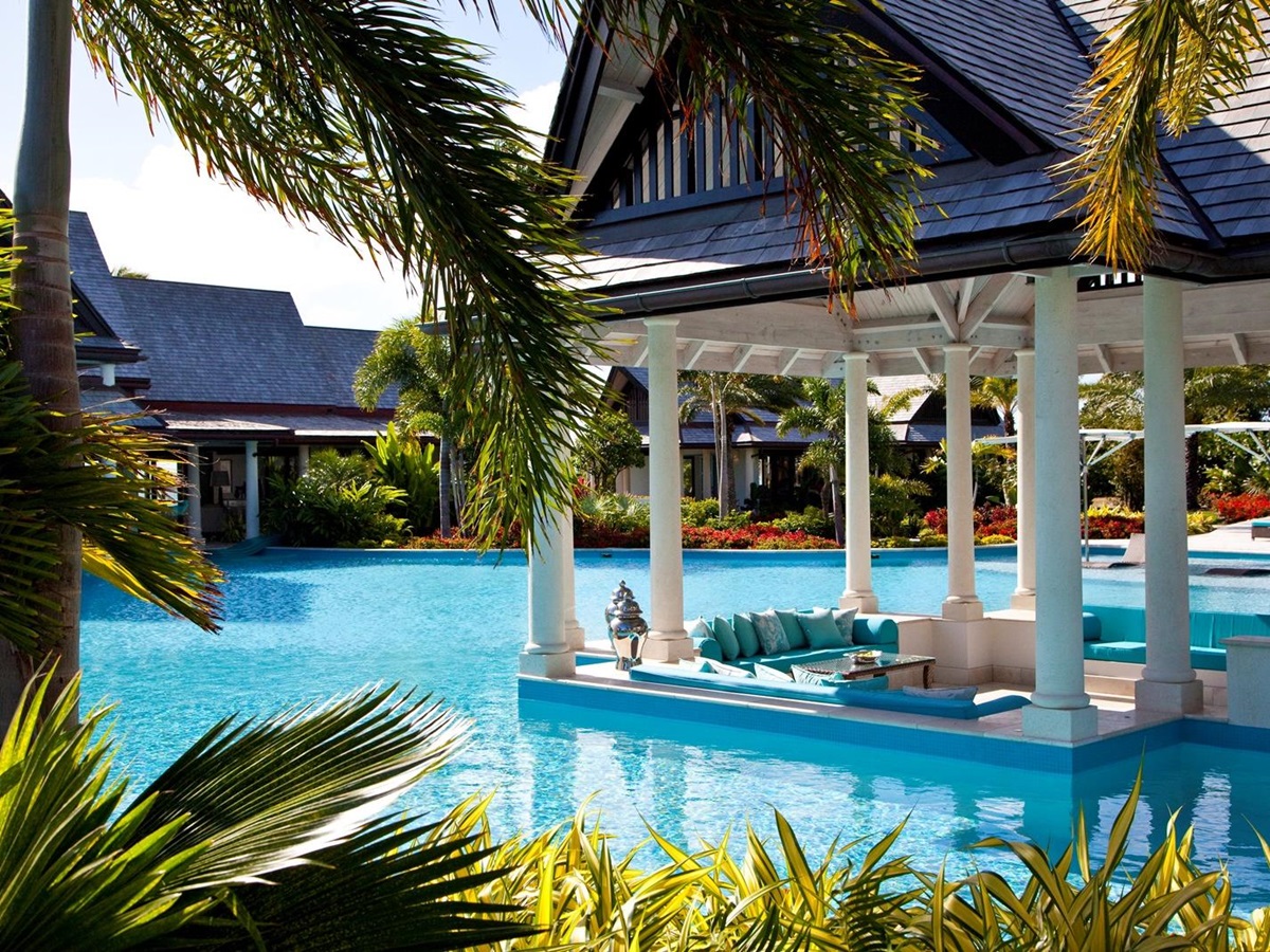 the dining area at the swimming pool at lazy lizard, antigua