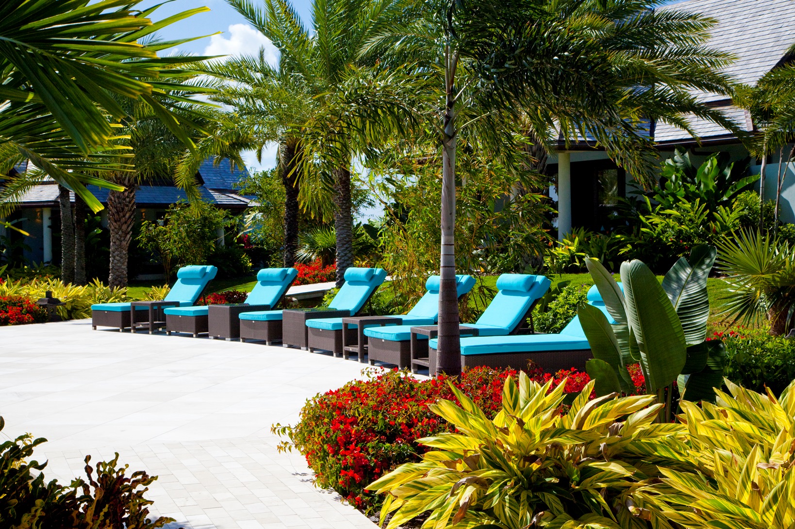 the sun loungers near the swimming pool of lazy lizard, antigua