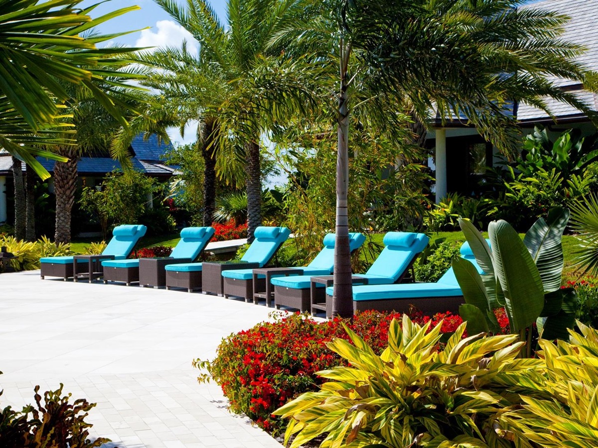 the sun loungers near the swimming pool of lazy lizard, antigua