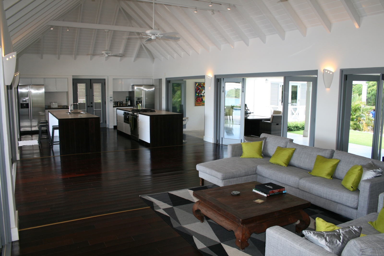 Living room with sofas and coffee table next to kitchen at The Hill Club in Antigua, the Caribbean