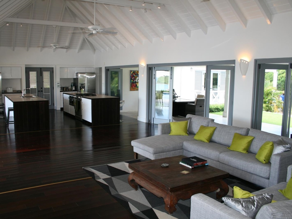 Living room with sofas and coffee table next to kitchen at The Hill Club in Antigua, the Caribbean
