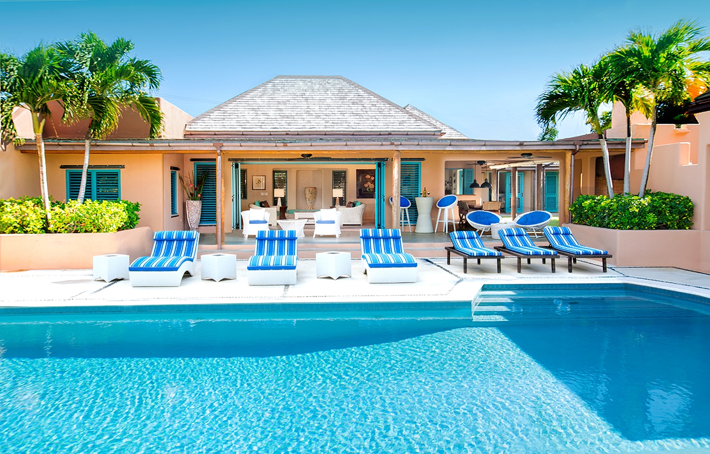Large pool with sun loungers and villa in the background at Villa Long Bay in Antigua
