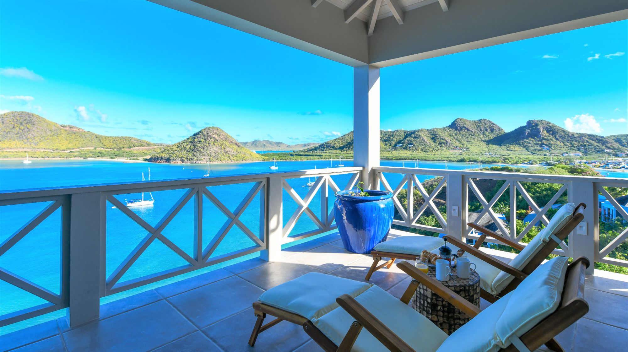 Balcony with loungers and sea view at Villa Papillon