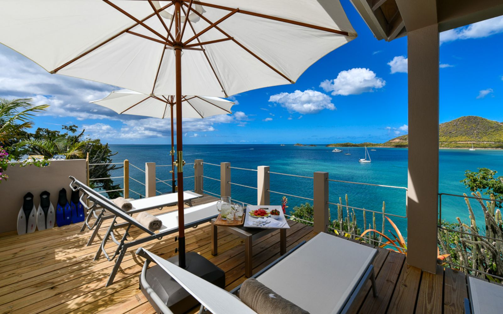 Terrace with loungers and sea view at Villa Papillon