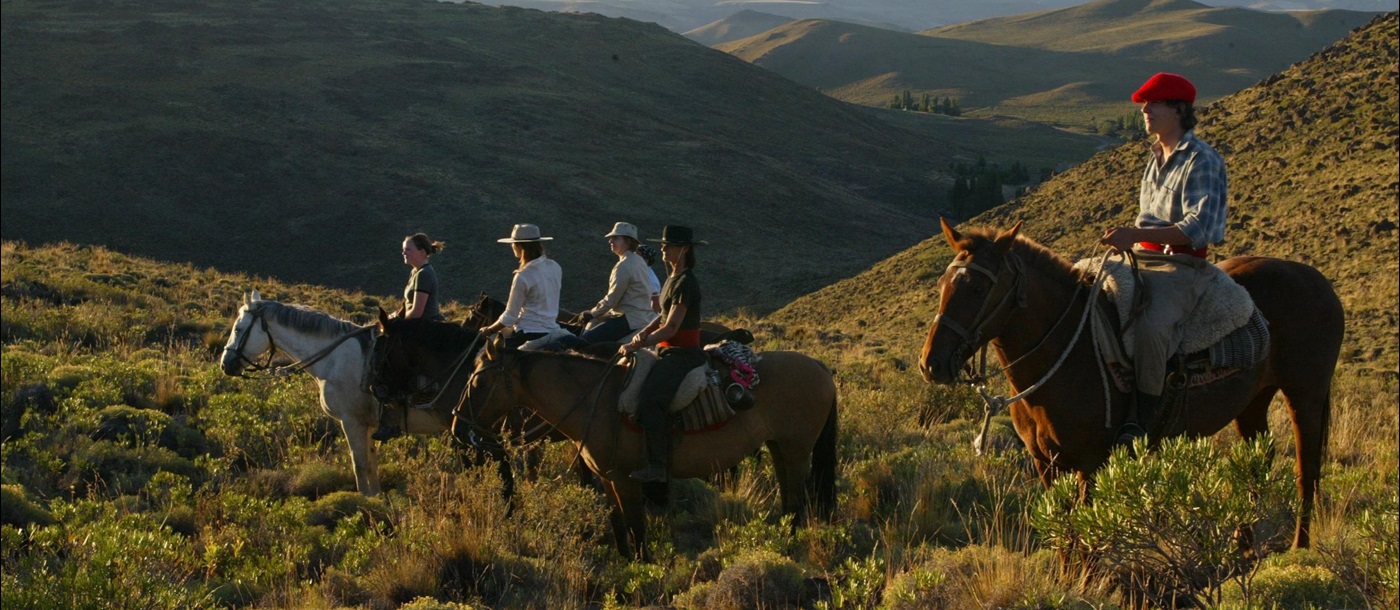 Four horse riders at Huechahue, Argentina