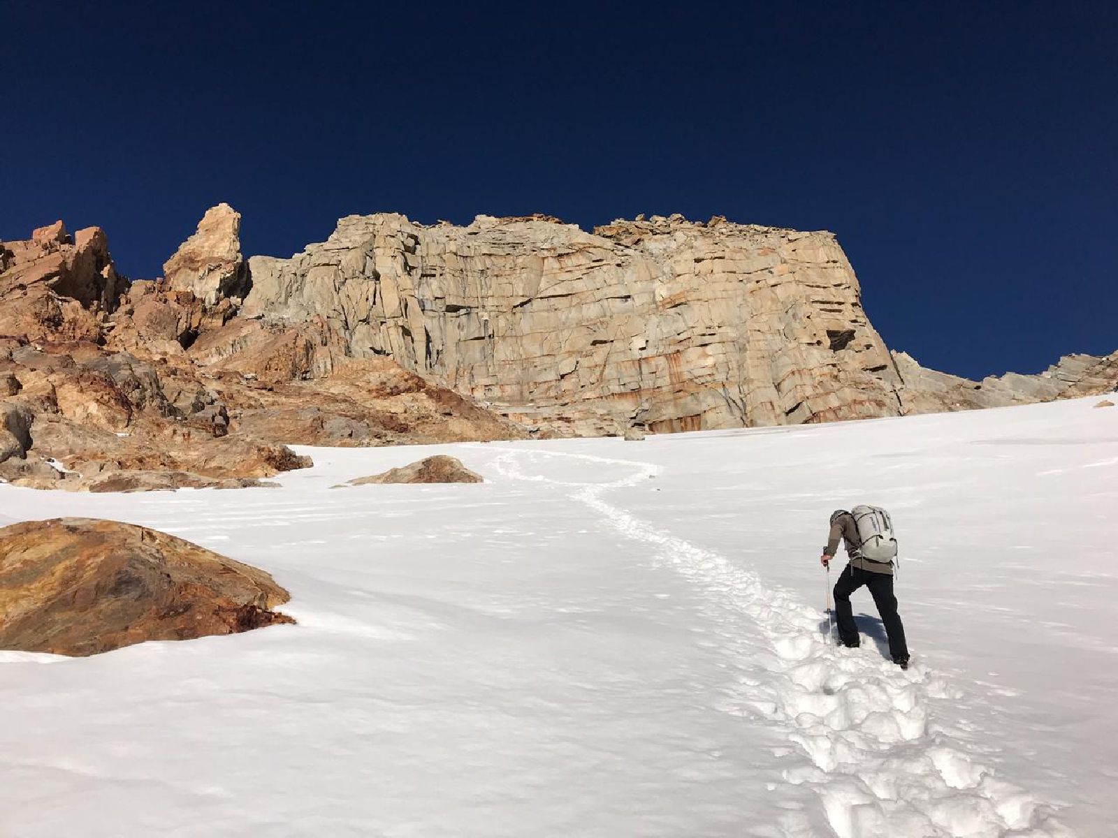 Guest hiking a snowcapped peak on an excursion from Explora El Chalten in Argentina